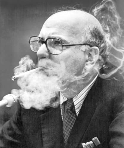 The financial wizard enjoyed cheap cigars, and brought plenty, while speaking on Capitol Hill.